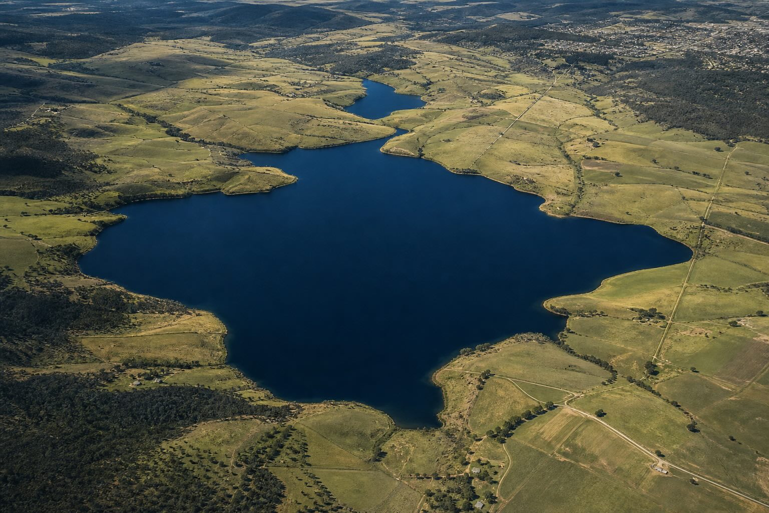 Aerial view of a lake and surrounding landscape used to illustrate territorial and market signals.